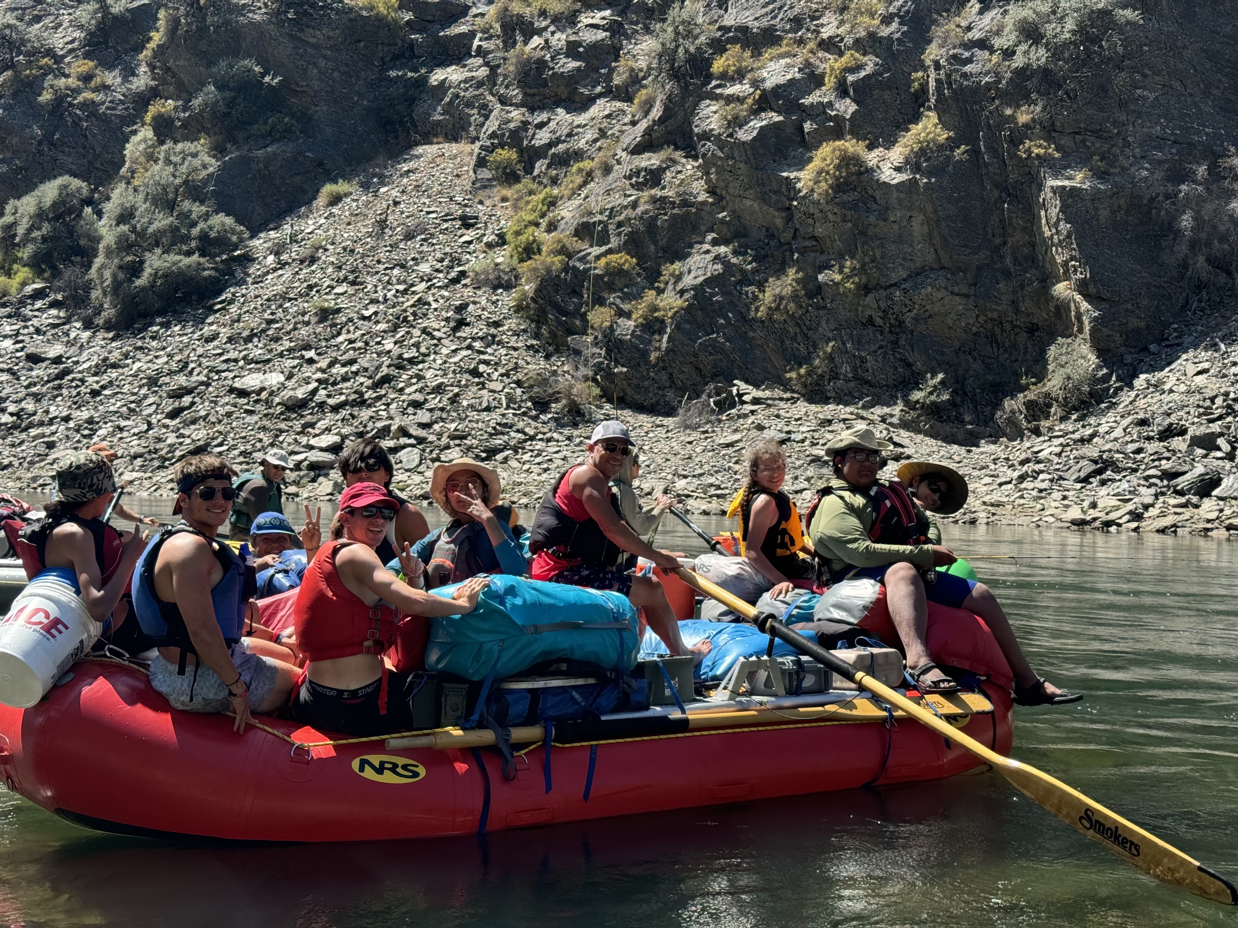 A group of people float on a raft on a river